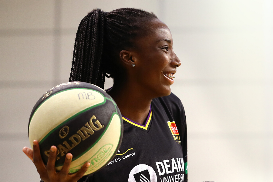 Ezi Magbegor smiling with basketball